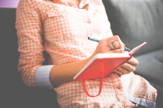 girl-writing-in-her-moleskine-diary-picjumbo-com